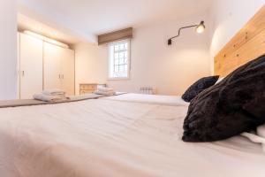 a large white bed in a room with a window at Warm and Inviting, Central location by urbanhosting in Santander