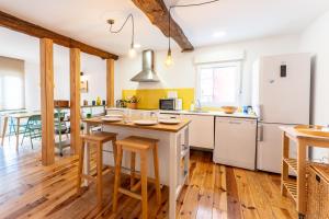 a kitchen with white appliances and wooden floors at Warm and Inviting, Central location by urbanhosting in Santander +11 photos