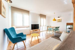 a living room with a couch and a table at Warm and Inviting, Central location by urbanhosting in Santander