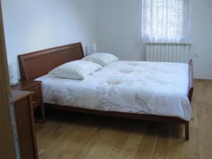 a bedroom with a bed and a wooden floor at House Dolenja Trebuša in Dolenja Trebuša