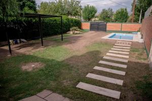 a backyard with a swimming pool and a gazebo at Casa Ezequiel in Villa Cura Brochero