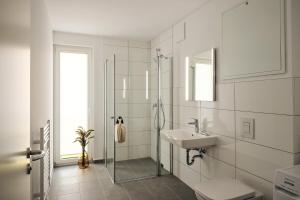 a white bathroom with a sink and a shower at Apartment B8 "Workation, Sauna & Fitness" im Pine Hill Resort in Zirchow +40 photos