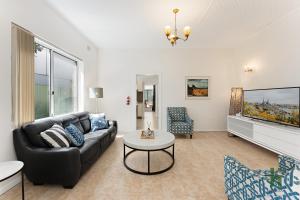 a living room with a couch and a table at edgeware house in Sydney