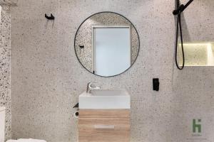 a bathroom with a mirror and a sink at edgeware house in Sydney +22 photos