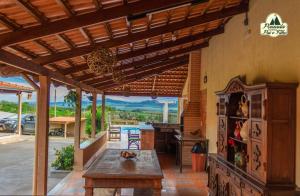 an outdoor patio with a wooden pergola at Pousada Canastra Pai e Filho in São João Batista do Glória