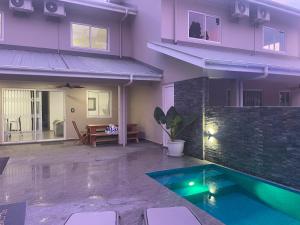 a house with a swimming pool in the backyard at Maison Marie-Jeanne in Praslin