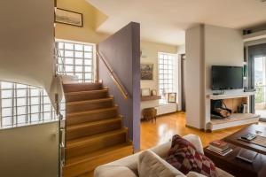 a living room with a couch and a staircase at Superb Athens Airport Residence, Unique View in Spáta +95 photos