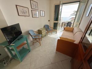ein Wohnzimmer mit Sofa und Fernseher in der Unterkunft Casa BELLAVISTA tra MARE e TERME in Santa Cesarea Terme