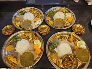 a bunch of plates of food on a stove at Pharping Homestay in Dakshīnkāli