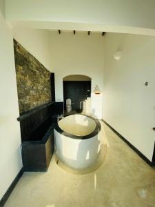 a large bathroom with a tub in the middle of a room at Southern grace unawatuna in Unawatuna
