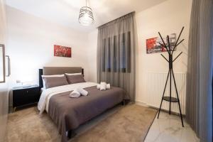 a bedroom with a bed with two towels on it at Filoxenia Luxury apartments Trikala 2 in Tríkala