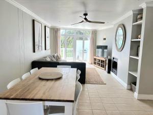 a living room with a table and a couch at Riptide at no 14 in Sea Vista