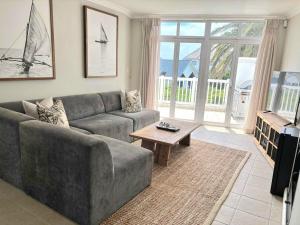 a living room with a couch and a table at Riptide at no 14 in Sea Vista