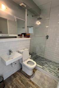 a bathroom with a toilet and a sink and a shower at Riptide at no 14 in Sea Vista +25 photos