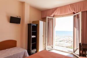 a bedroom with a view of the ocean at Hotel Negresco in Milano Marittima +210 photos