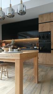 a kitchen with a wooden table in a room at Fabryka Snów in Ochotnica Górna