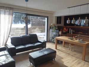 a living room with a couch and a table at Fabryka Snów in Ochotnica Górna