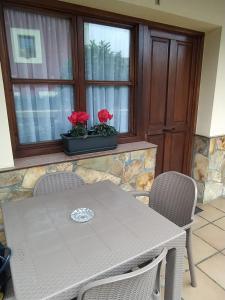 a table and chairs in a room with a window at Apartamentos La Tarazana 2 in La Pereda de Llanes