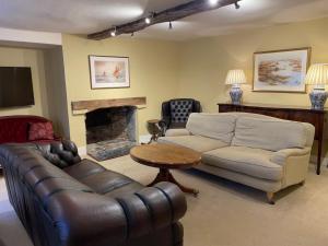 a living room with a couch and a fireplace at Malabar House in Lyme Regis