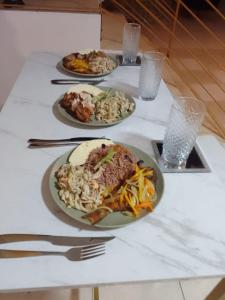 a table with three plates of food on it at Belle Air Seaview : The Master in Browns Town +7 photos