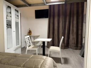 a bedroom with a bed and a table and chairs at Attardo's House in Catania