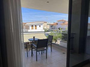 a view of a balcony with a table and chairs at Centrum Rooms in Kallithea Halkidikis