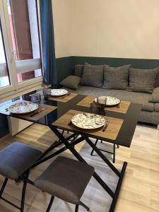 a living room with three tables and a couch at Entre lac et montagne 2 in Sévrier