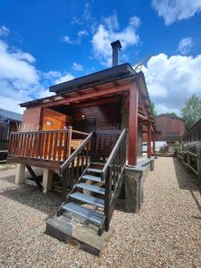a small building with a staircase leading to a house at Chalet en Eyne Cambre d'Aze in Eyne