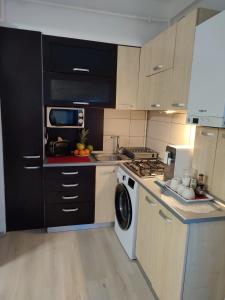 a kitchen with a stove and a washing machine at Cristina's Place!! in Sibiu