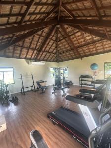 a gym with treadmills and exercise equipment in a room at Bangalo Luxo Praia dos Carneiros Beach Resort in Praia dos Carneiros