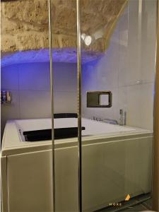 a bathroom with a white tub and a sink at More Apartments Blue Arch suite in Bari +13 photos
