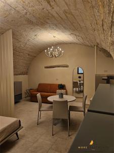 a living room with a couch and a table at More Apartments Blue Arch suite in Bari