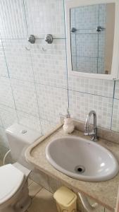 a bathroom with a sink and a toilet and a mirror at Raízes e Horizontes Hostel in Morungaba +11 photos