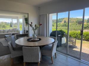 a living room with a table and chairs at Wineries and cycle tracks on your doorstep in Havelock North