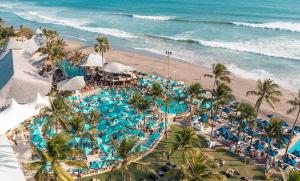 an overhead view of a beach with a pool and the ocean at villa Noham canggu 5mn beach in Canggu