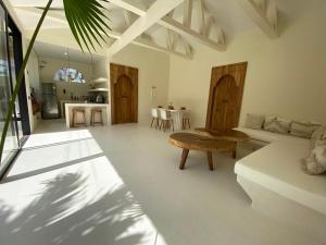 a living room with a couch and a table at villa Noham canggu 5mn beach in Canggu