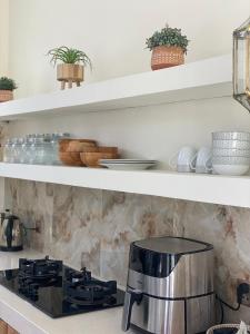 a kitchen with a stove and a pot on a counter at villa Noham canggu 5mn beach in Canggu +10 photos