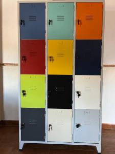 a row of lockers with different colored doors at El Patio del Molino - Hostal Rural in Villanueva del Trabuco