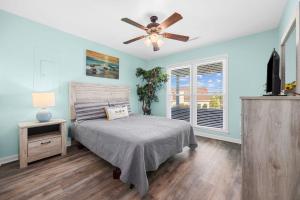 a bedroom with a bed and a ceiling fan at NEW POOL & Spa Coming May 2025 - NEW HOT TUB Available now- Dog friendly 4BR private home 6Min Walk to Beach in Myrtle Beach