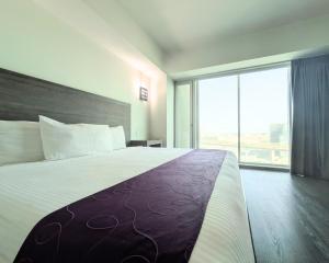 Una cama o camas en una habitación de We Hotel Aeropuerto