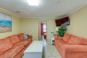 a living room with a couch and a table at Less Than half Mi to Beach Wildwood Getaway with Patio! in Wildwood