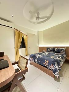 una camera con letto, scrivania e soffitto di NEWLY RENOVATED Comfy Beachfront View At Seri Bulan Port Díckson a Port Dickson