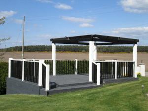 a gazebo in a field with a fence at Broomlea in Inverness