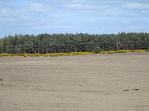 an empty soccer field with a fence in the background at Broomlea in Inverness
