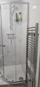 a shower with a glass door in a bathroom at Abi's World - 23 Kilmartin Grove Green, Hollystown, Dublin 15 in Dublin