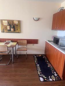 a kitchen with a table and a microwave at Apartment del Sol in Varna City