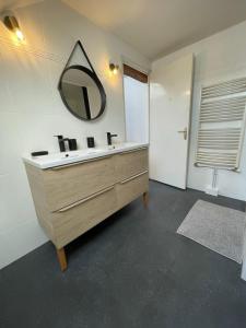 a bathroom with a sink and a mirror on the wall at Belle maison de ville in Alençon