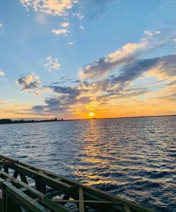 a sunset over a large body of water at Che Cambá in Colonia Carlos Pellegrini