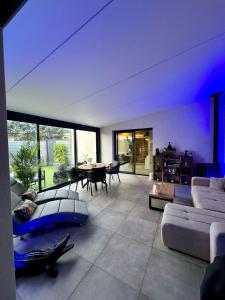 a large living room with a couch and a table at Suite Romantique Reve d Amazonie option espace Spa complet en supplément in Les Mages