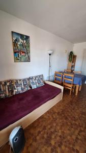 a bedroom with a large bed and a table and chairs at Le Petit Bouleau in Saint-Pardoux-la-Rivière